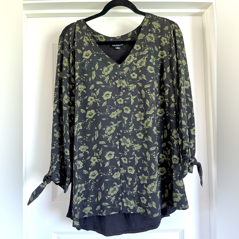 Black with green 3/4 sleeve blouse with sweet tie detail at bottom of sleeve.